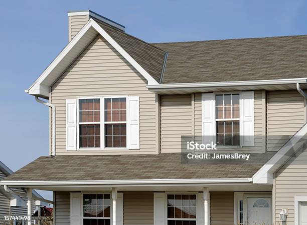 Residential Home With Vinyl Siding Gable Roof Seamless Gutters Shutters Stock Photo - Download Image Now