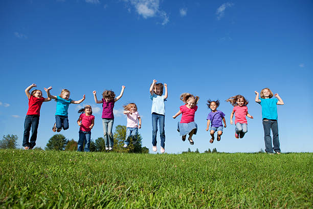 istock Happy girls jumping outdoors 157441562