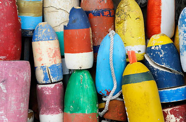 Closeup of very colorful fishing buoys Close up of a group of colorful fishing buoys. More New England coast images in lightbox below... buoy stock pictures, royalty-free photos & images