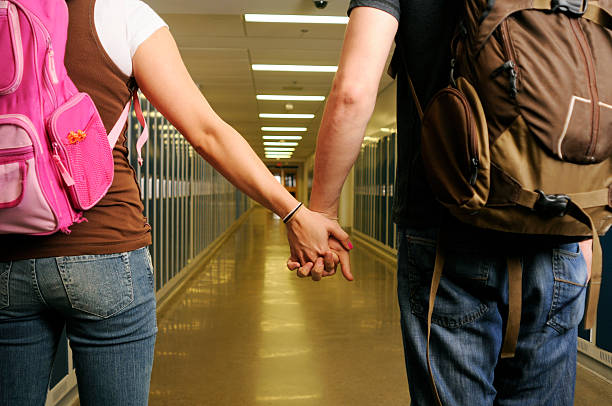 High School Couple Holding Hands From Behind  ass boy stock pictures, royalty-free photos & images