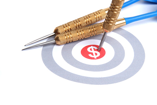 Darts stuck in a target - sales target concept