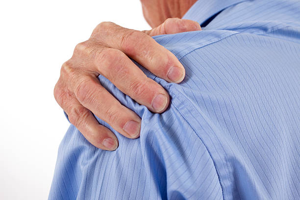 istock Senior man with hands rubbing shoulders and neck in pain 157441845