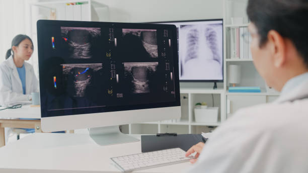 Adult Asian male doctors medical checking x-ray image of patient on computer screen in hospital. Medical health care. Adult Asian male doctors medical checking x-ray image of patient on computer screen in hospital. Medical health care concept. cancer screening stock pictures, royalty-free photos & images