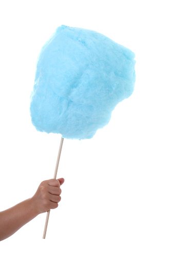 Blue cotton candy in child's hand isolated on white