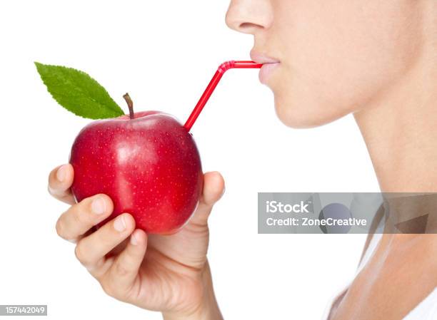 Girl Drinks Fruit Juice From An Apple Stock Photo - Download Image Now - Apple Juice, Drinking, Juice - Drink