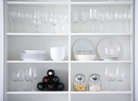 White kitchen cupboard filled with glassware and other items.

[url=/file_search.php?action=file&lightboxID=4658731]