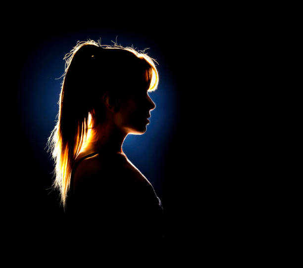 istock Silhouette of woman's head with ponytail 1574422261