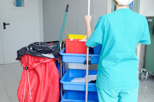 Cleaner ready for washing hospital corridor