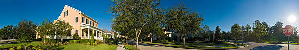 Suburban street sunrise stop sign Picturesque luxury home with wooden verandah in traditional style overlooking quiet suburban streets under clear blue panoramic skies in this tranquil Florida community. ProPhoto RGB profile for maximum color fidelity and gamut. orlando florida photos stock pictures, royalty-free photos & images