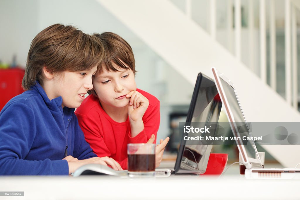 Children and Laptop Two happy boys using a laptop together... 10-11 Years Stock Photo