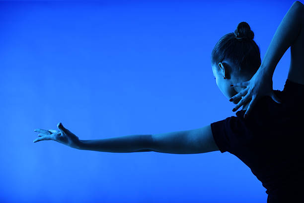 Dancer woman dancing on a blue background performing arts event stock pictures, royalty-free photos & images
