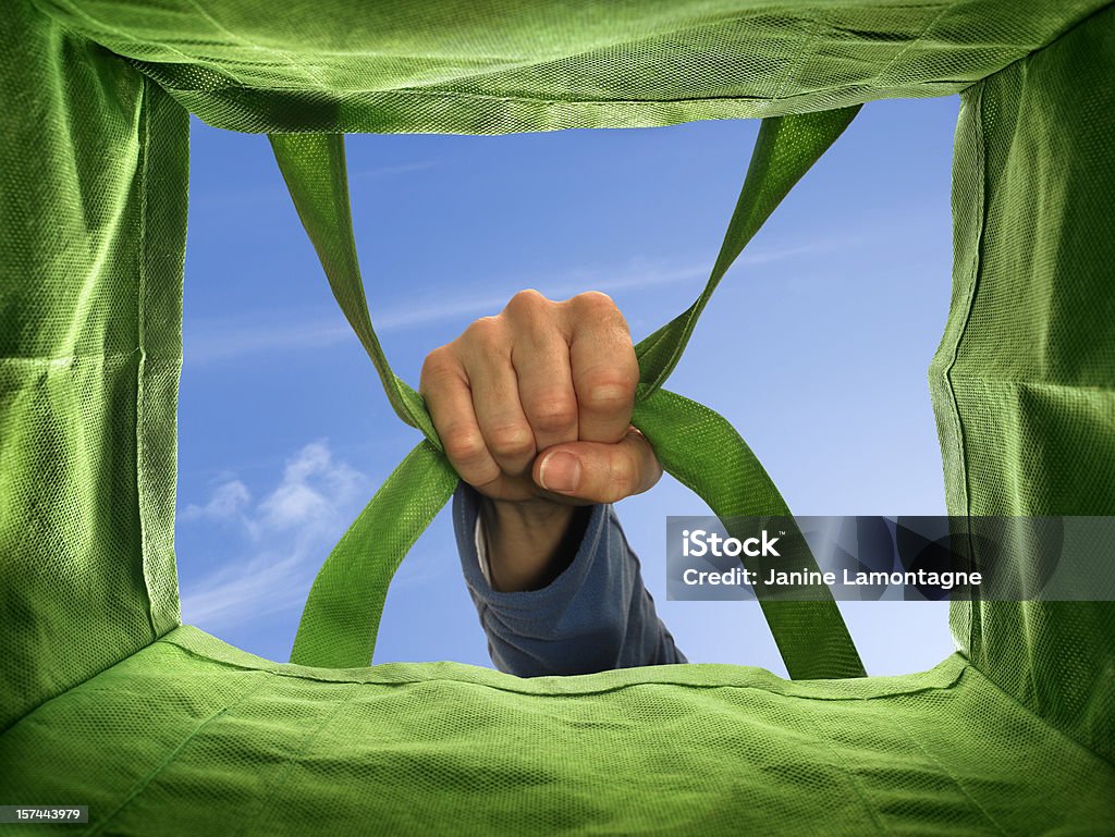 Carrying a bag Picking up a reusable shopping bag. Perspective from the inside of the bag. Bag Stock Photo