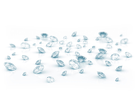 Diamonds scattered on shiny white background