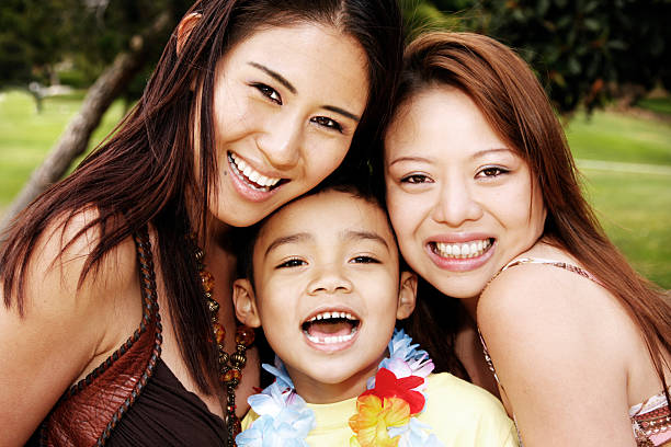 istock Two women and a boy smiling at the camera 157444266