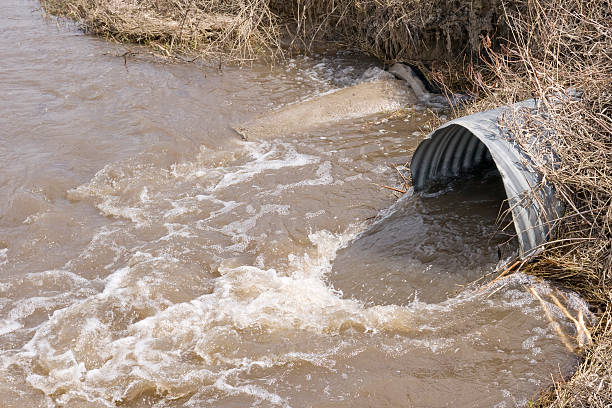 istock flood water draining from metal conduit 157444338