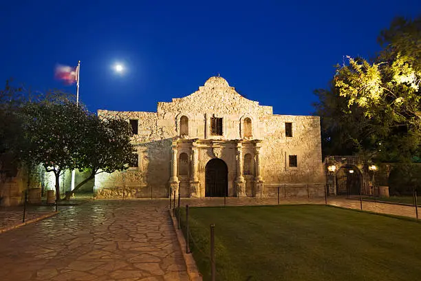Subject: Alamo memorial in the evening with a full moon.