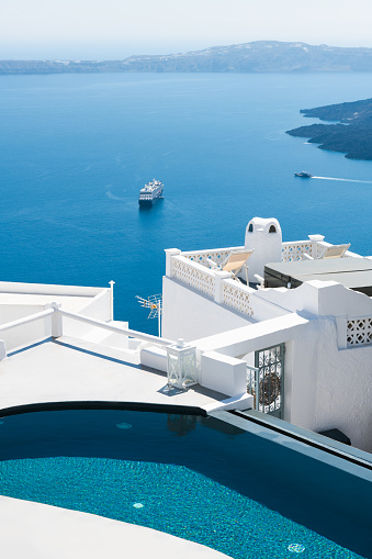 White architecture in Santorini island, Greece. Luxury swimming pool with sea view. Travel and vacation concept