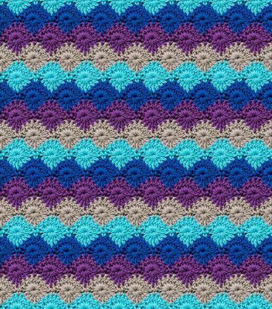 istock Seamless knitted texture in the form of daisies. The pattern is crocheted from multicolored cotton yarn. 1574483554