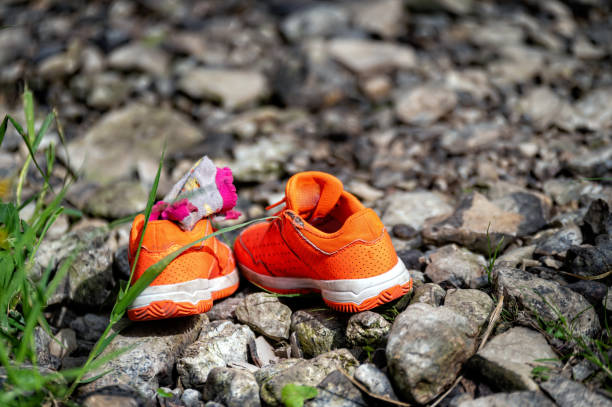istock orange children's sneakers on a rocky surface, close-up 1574505006
