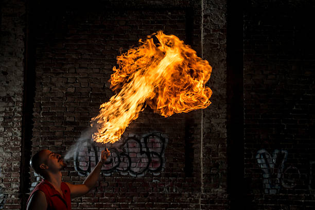 istock Street Performer Fire Breather Blowing on Torch 157450715