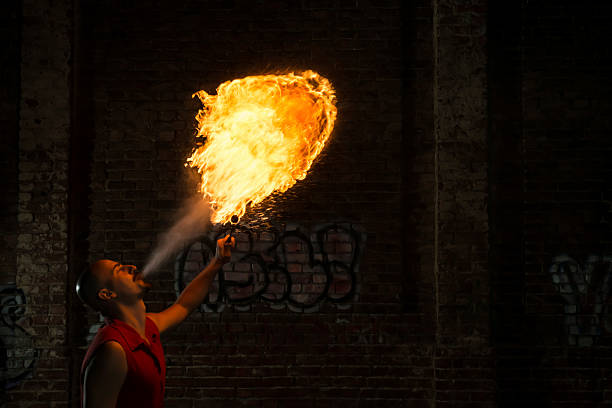 istock Street Performer Fire Breather Blowing on Torch 157450801
