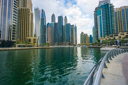 Dubai, UAE - December 5. 2019 - People go for a walk in an ultra modern city - Dubai Marina.