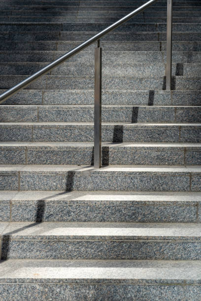 istock stone staircase and stainless steel railing 1574521746