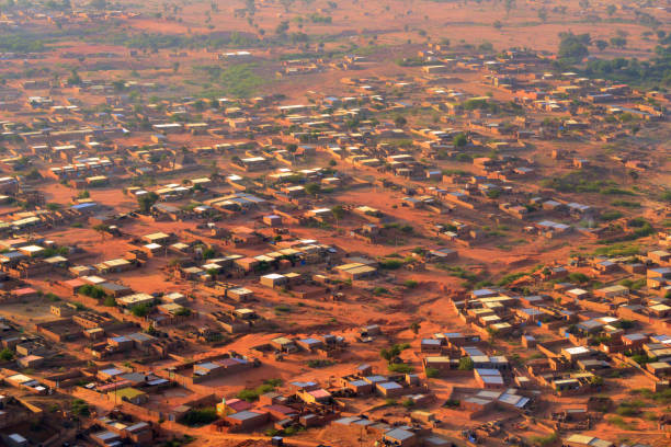 Pays Bas-Tondi Gammé / Tondigamay, Niamey, Niger: dusty and street-less suburb, adobe / mud brick houses in the western part of the city - pattern of houses and red earth - Niamey IV area. African suburb - aerial view.