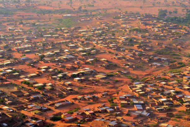 Pays Bas-Tondi Gammé / Tondigamay, Niamey, Niger: dusty and street-less suburb, adobe / mud brick houses in the western part of the city - pattern of houses and red earth - Niamey IV area. African suburb - aerial view.