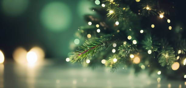 Beautiful Christmas background image in green tones. Beautiful Christmas defocused blurred background with Christmas tree lights in the evening. christmas tree stock pictures, royalty-free photos & images