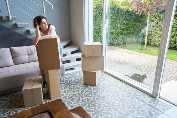 istock Pretty female lost in thought in modern room 1574561951