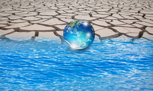 istock Water crisis and Climate change concept with earth planet on dry soil and water 