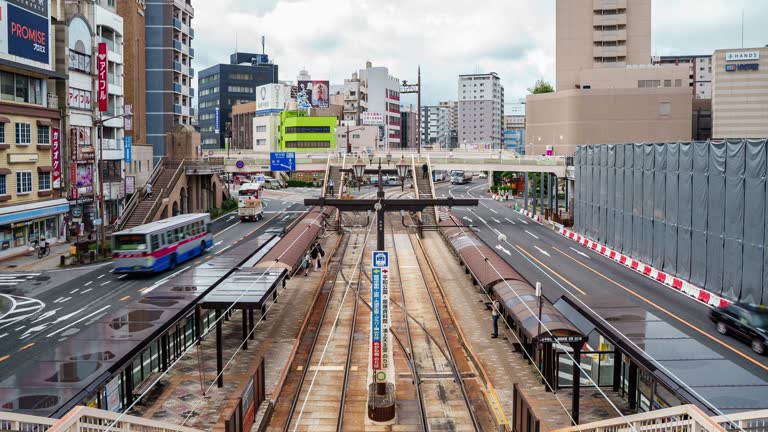 Time lapse view of car and other vehicle, tram streetcar driving along main road in Nagasaki city Kyushu Japan. East Asia urban lifestyle transportation concept.