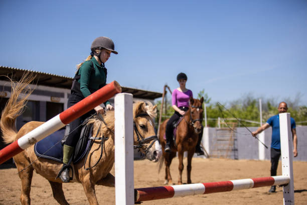 istock Girls on horse riding lessons 1574607961