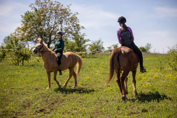 istock Girls riding horses 1574612317