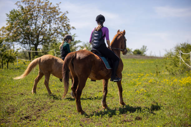 istock Girls riding horses 1574613391