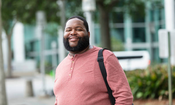 African-American man with beard walking in city