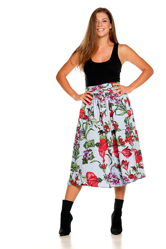a young beautiful smiling woman in skirt and a shirt in a white background