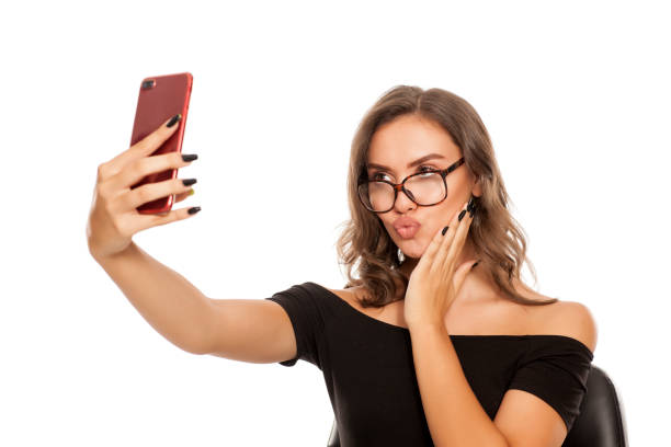 istock Young beautiful woman take selfies on white background 1574669770