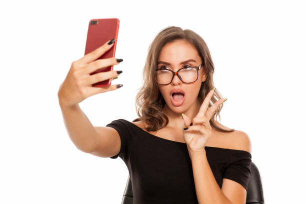 istock Young beautiful woman take selfies on white background 1574669775