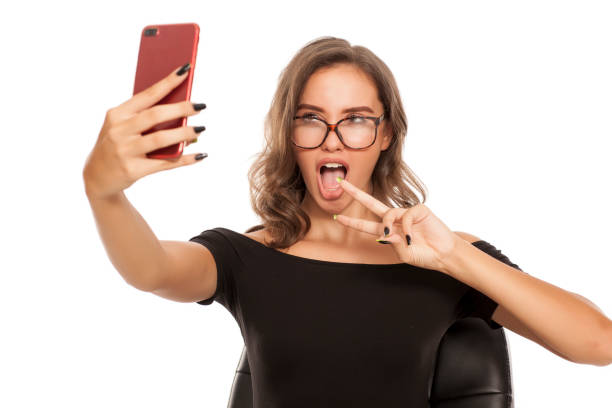 istock Young beautiful woman take selfies on white background 1574669778
