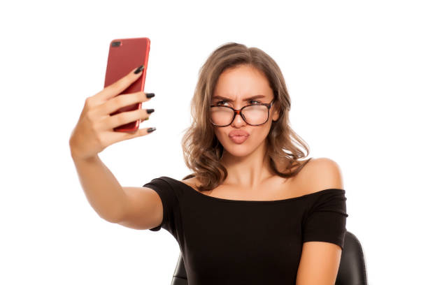 istock Young beautiful woman take selfies on white background 1574669780