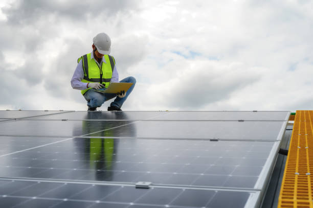 istock Engineers or Specialist Technicians Check Quality of Installing Solar Photovoltaic Panels and Use App Technology Checking Accumulated power generation from Solar Panel on Laptop. 1574676545