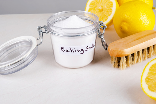 Baking soda and lemon on a gray background.The concept ecological cleaning, disinfecting, removing stains