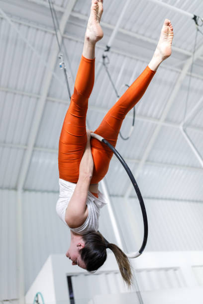 istock Woman doing gymnastics with a lyra hoop 1574685731