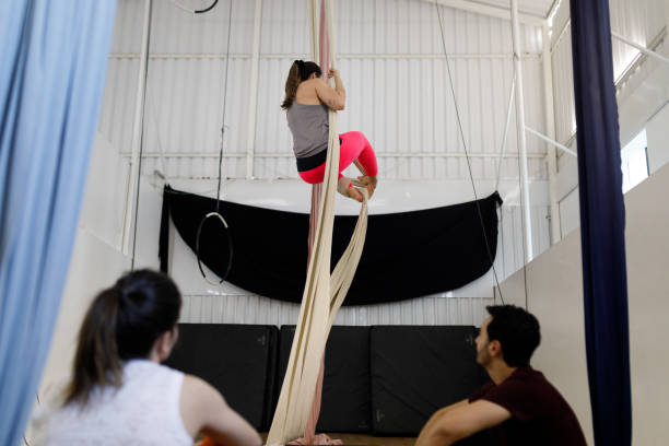 istock Woman climbing silk on aerial gymnastics class 1574686765