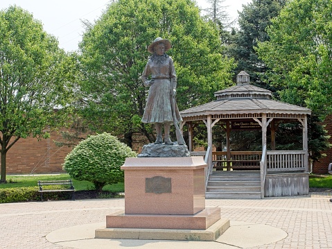 Greenville, Ohio - USA, May 18, 2023. Annie Oakley statue and memorial in downtown Greenville Ohio - USA. Famous sharpshooter and star of the Buffalo Bill show was born and resided in Darke county Ohio.