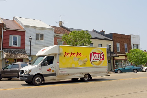 Greenville, Ohio - USA, May 18, 2023. Lay's potato chip delivery van drives down Broadway in downtown Greenville Ohio - USA.