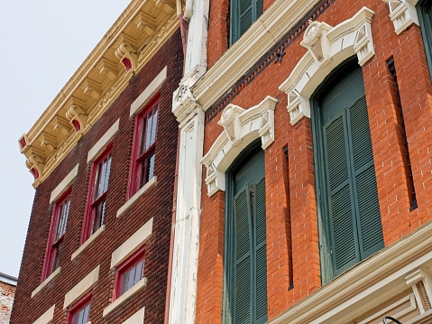 Contrasting red brick and green shutters on old circa 1900 construction in downtown Greenville Ohio.