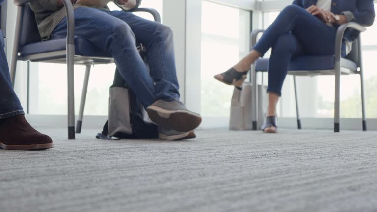 Unrecognizable people waiting for appointments in bank or medical clinic